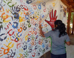 A student works on a mural to advocate for the end of bonded labour.